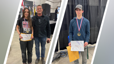 Two student winners pose for photo with their medals