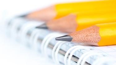 iStock - Pencils 3 Pencil ends sitting on a notebook