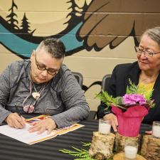 Two leaders signing the new enhancement agreement