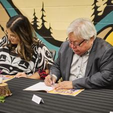 Two leaders signing the new enhancement agreement